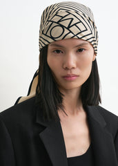 Centered monogram silk scarf crème